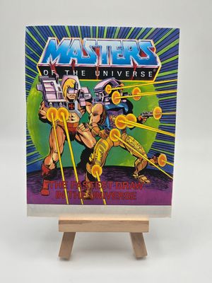 Front the English cover of a vintage &#39;Masters of the Universe&#39; mini comic titled &#39;The Fastest Draw in the Universe&#39;, featuring He-Man and allies equipped with advanced weaponry poised in dynamic action.