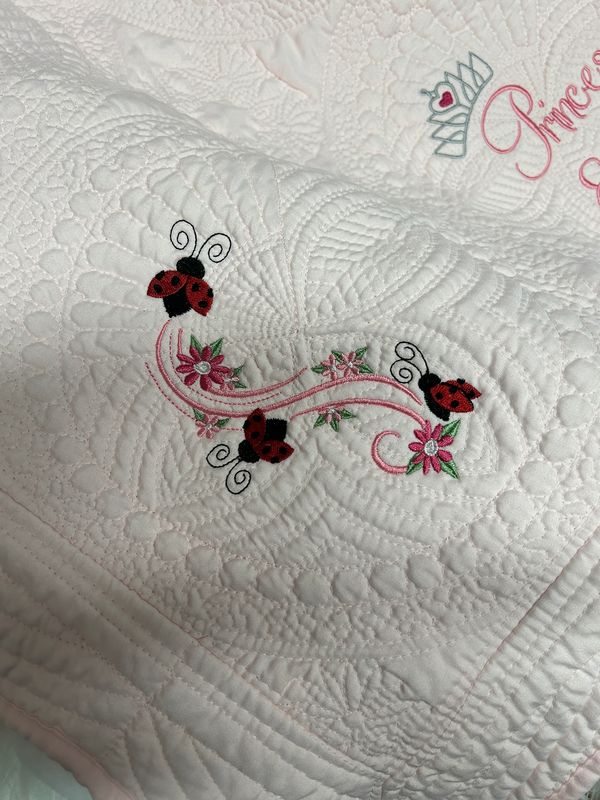 Baby Girls Pink Embroidered Heirloom Quilt, every corner medallion has a unique Lady Bug Design, in addition to personalization