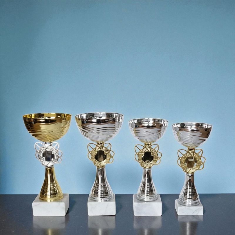 Vier Pokale Modell Emily mit silbernem und goldfarbenem Kelch, dekorativem Mittelteil und weißem Marmorsockel