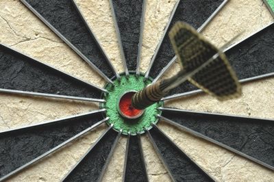 dartsboard mit pfeil im bullseye pokale und trophies für den dartssport