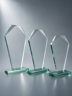 Jadeglas-Trophäe Jadeglas-Trophäe mit Facettenschliff und Emblemträger aus grünem Glas auf graublauem Hintergrund.