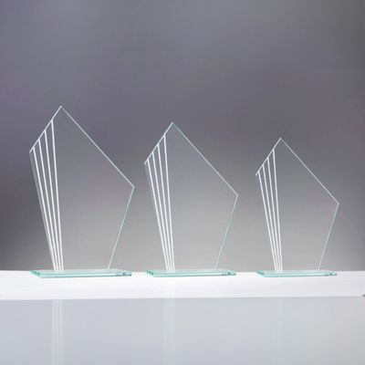 Drei schräge Glastrophäen aus 4 mm starkem Glas mit spiegelnden Ornamentlinien in abgestuften Größen