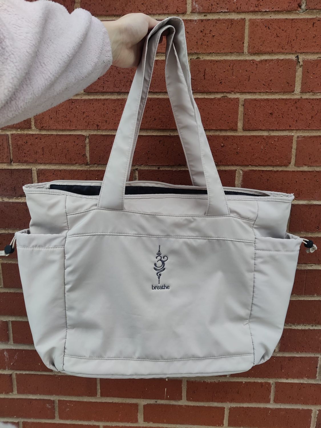 Sage green yoga bag with breathe embroidery on the side
