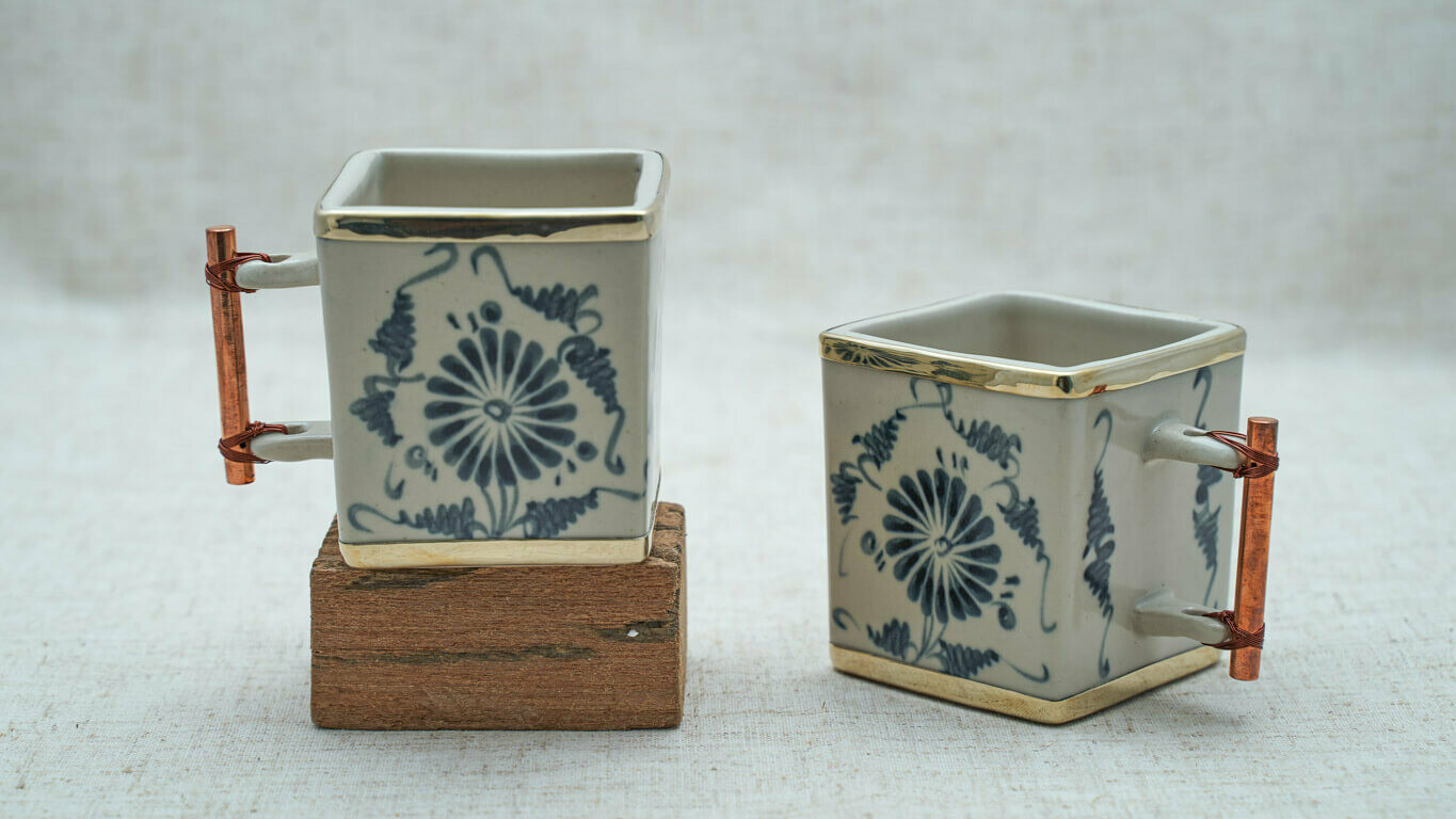 Square teacups with daisy motifs