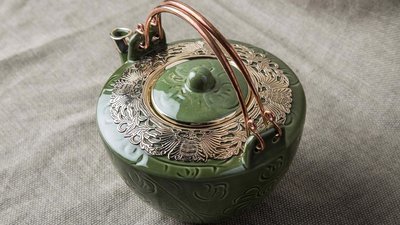 Deep green teapot with bronze decoration