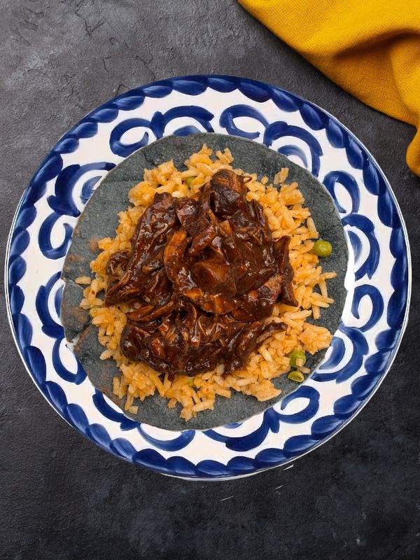 Tacos con mole rojo acompañado con arroz rojo