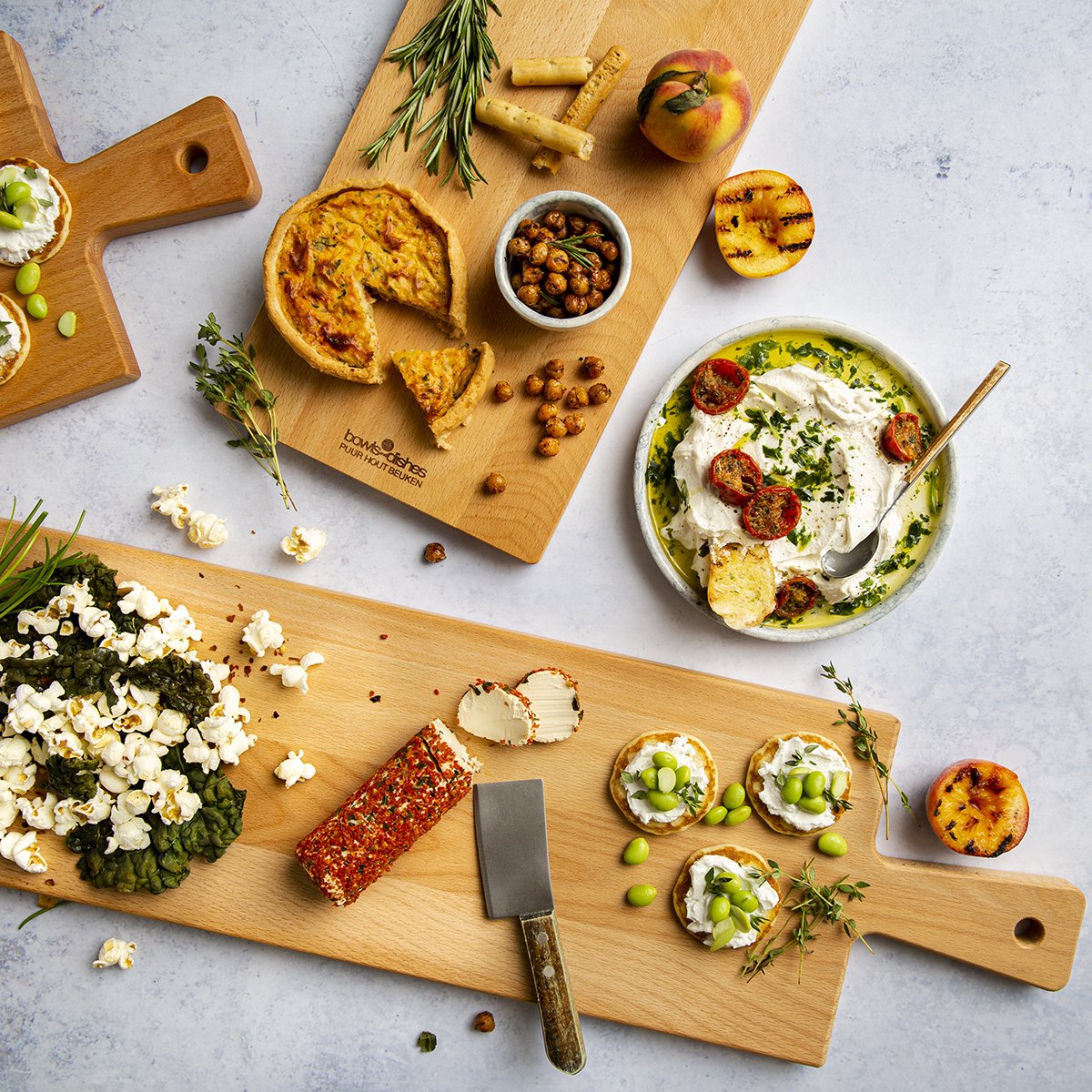 Houten serveerplank met schaaltje met Prosecco of olijfolie, noten en chocolade