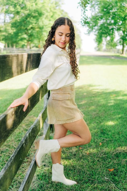 Side view of tan denim skort with white