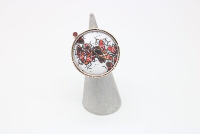 Charity Hall: Milkweed bugs ring with garnet in sterling