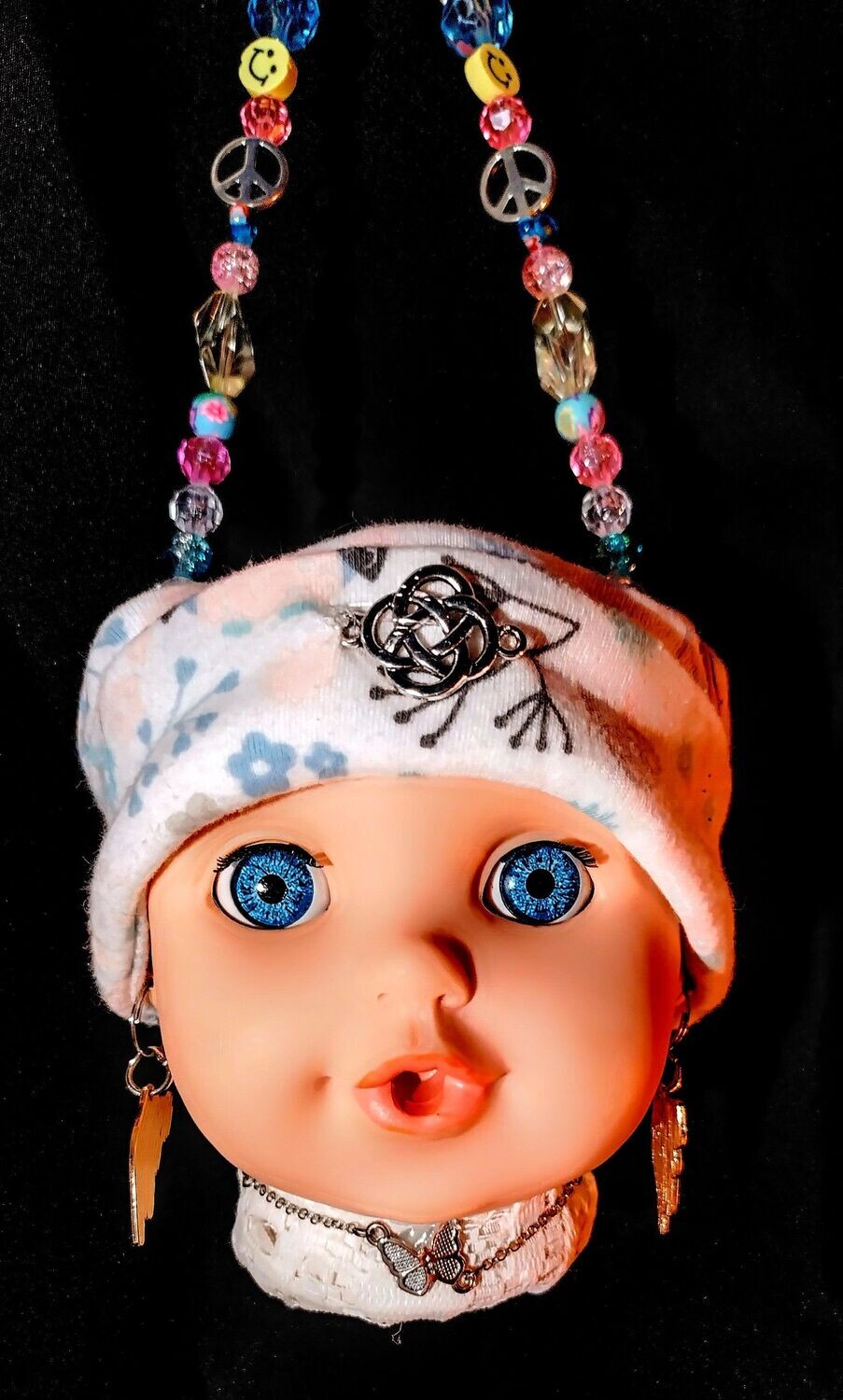 Hanging doll head plant holder