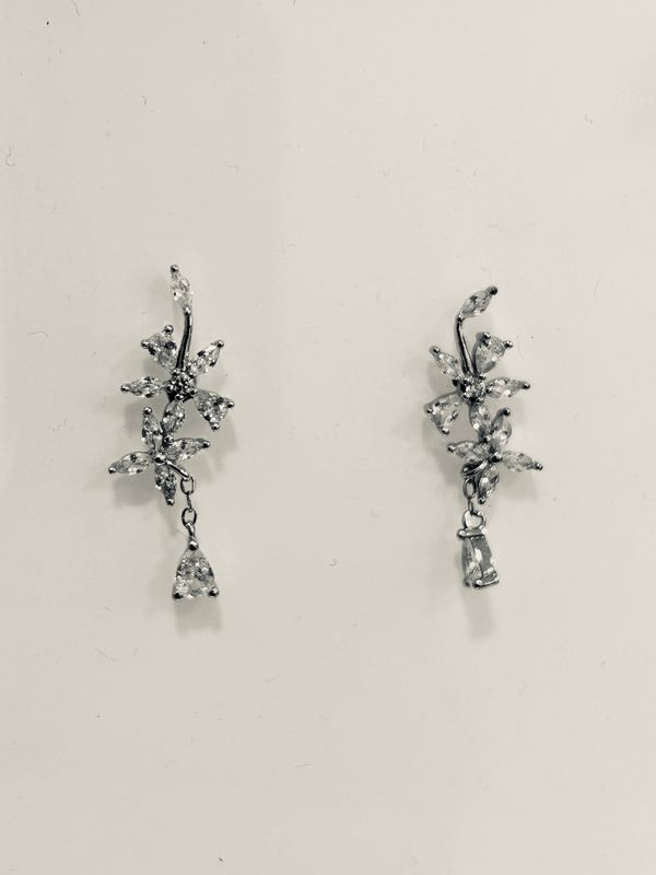Oorbellen stekers met bloemvormige zirkonen en een hangend steentje