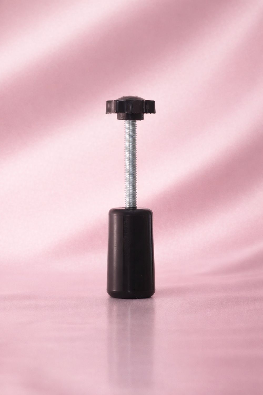 Hand held collar pump perfume bottle capping tool.