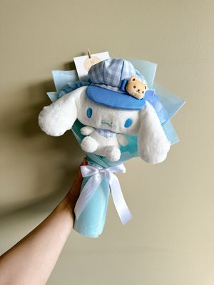 Cinnamoroll plush toy wearing a hat and scarf from japan wrapped with roses in a bouquet