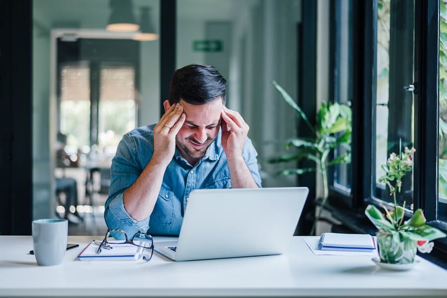 Man Sits at Desk