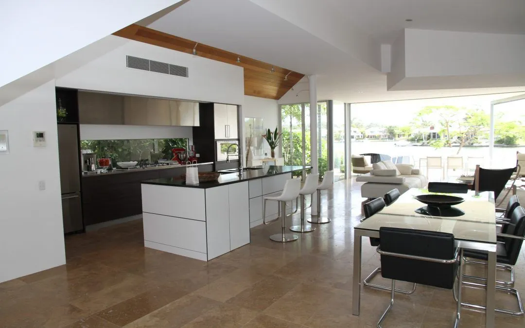 A living room with a table and chairs and a kitchen