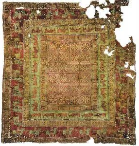A very old rug with a square pattern on it