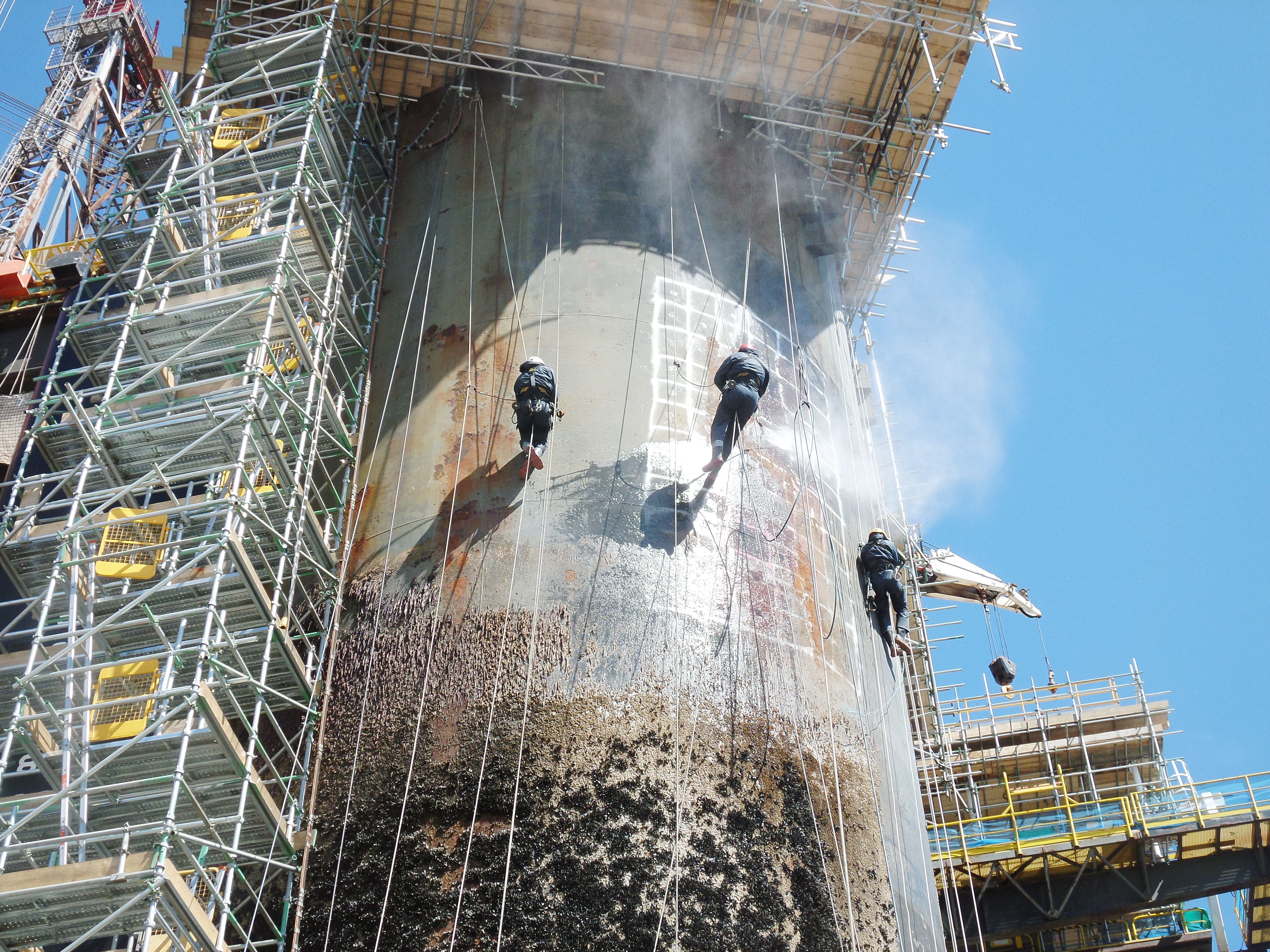 a shipyard at work with scaffolding and abseiling 