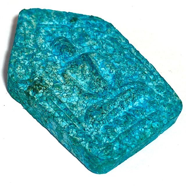 Amulet scene from a left 45 degr ee angle laid flat on a white background showing the front face of the amulet