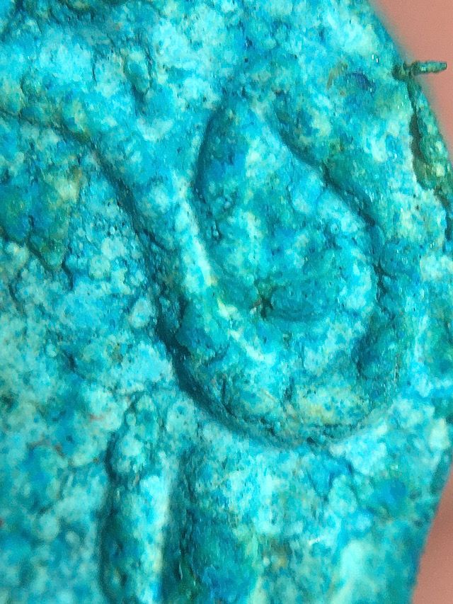 Extreme macro close up of the top right edge of the front face of the amulet above the pillar