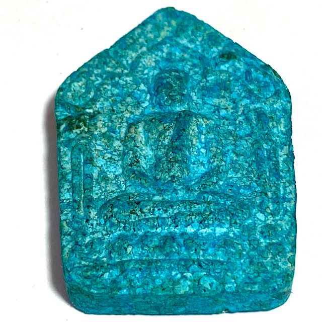 Front face of the amulet laid flat on a white background seen from the bottom edge showing the front face in perspective