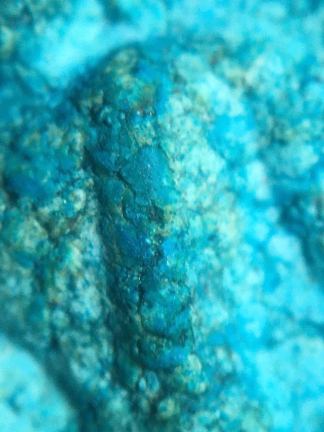 Close up of the admixture of the amulet revealing the sacred sticky rice present within the sacred clay to a high degree