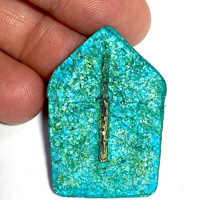 Rare face of the amulet full frontal supported from behind by the hand