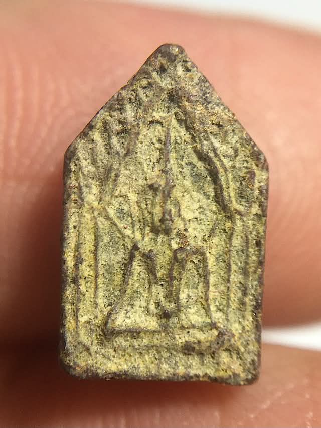 Pra Khun Phaen amulet of Luang Phu Gaew Wat Laharn Rai held in hand for size comparison, showing its miniature size, despuite which, the amulet has immense detail and relief in its design