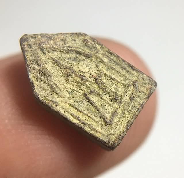 45 degree angled view of Pra Khun Phaen amulet of Luang Phu Gaew Wat Laharn Rai in hand