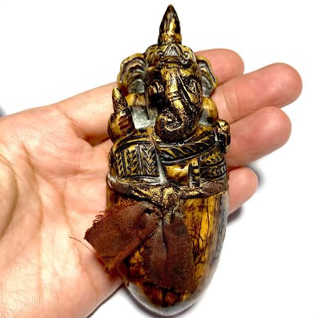 Pra Pikanes Ivory Tusk carved into Ganesha God Luang Por Derm in hand for size comparison