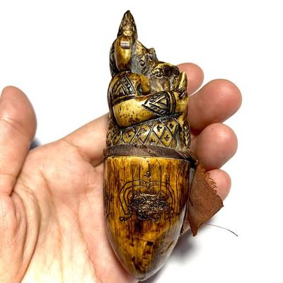 Pra Pikanes Nga Gae LP Derm Puttasaro Wat Nong Po side view in hand - right side of tusk