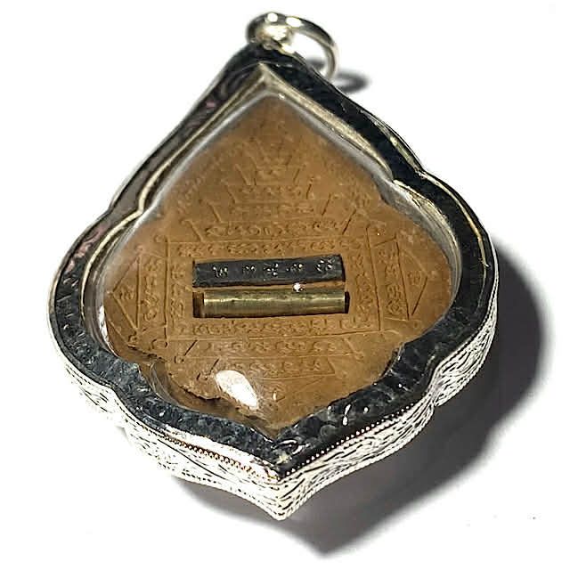 Rear face edge view of Pra Rahu amulet in silver micron casing (waterproof) from Luang Pu Bun Ma