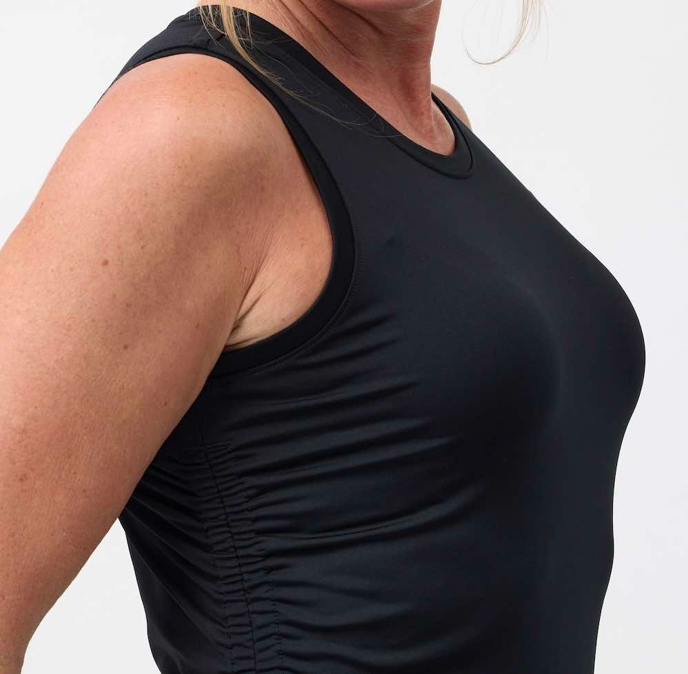 Close up photo of the 4 way stretch black fabric top
